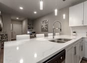 Thumbnail 4 of 37 - an open kitchen with white counter tops and a sink at Annandale Apartment Homes, Murfreesboro, Tennessee