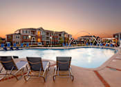 Thumbnail 28 of 37 - a swimming pool with chairs at dusk at Annandale Apartment Homes, Murfreesboro, Tennessee