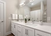 Thumbnail 12 of 37 - a white bathroom with two sinks and a mirror at Annandale Apartment Homes, Murfreesboro, Tennessee