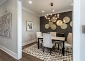 Thumbnail 6 of 37 - a dining room with a table and chairs and a chandelier at Annandale Apartment Homes, Murfreesboro, TN