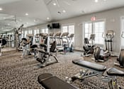 Thumbnail 17 of 37 - a gym with cardio equipment and weights on the floor at Annandale Apartment Homes, Murfreesboro, TN, 37128