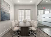 Thumbnail 24 of 37 - a conference room with a wooden table and white chairs at Annandale Apartment Homes, Murfreesboro