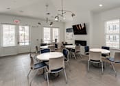 Thumbnail 22 of 37 - a dining room with tables and chairs and a fireplace at Annandale Apartment Homes, Tennessee 37128