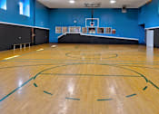 Thumbnail 13 of 23 - an indoor basketball court with a basketball hoop in the middle