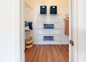 Thumbnail 8 of 48 - A white hallway with a shelf and two speakers on top.