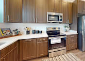 Thumbnail 4 of 57 - Kitchen with Wooden Cabinets at Artesia at Lakewood Ranch Apartments, Bradenton, Florida