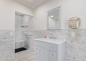 Thumbnail 14 of 26 - a bathroom with a shower and a sink