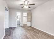 Thumbnail 7 of 14 - an empty living room with a ceiling fan