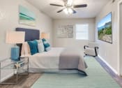 Thumbnail 5 of 14 - a bedroom with a bed and a ceiling fan