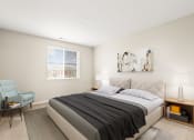 Thumbnail 19 of 44 - a bedroom with a bed and a chair