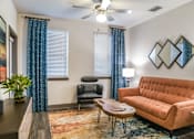 Thumbnail 8 of 65 - A living room with a brown couch, a chair, a table, and a potted plant. at Centre Pointe Apartments, Melbourne, 32940