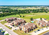 Thumbnail 11 of 14 - an aerial view of a large neighborhood of houses and a field