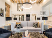 Thumbnail 14 of 34 - white couch with pillows and lighting above at Magnolia Square, Naples