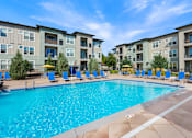 Thumbnail 32 of 47 - Swimming Pool with Relaxing Area at WestLink at Oak Station Apartments, Lakewood