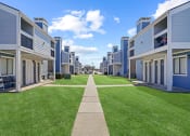 Thumbnail 21 of 24 - blue building and sky and green grass