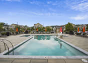 Thumbnail 12 of 29 - a swimming pool with lounge chairs and umbrellas at Parc at Princeton Junction Apartments, Princeton