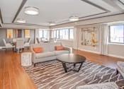 Thumbnail 22 of 43 - a living room and dining room with couches and a table at 10 West Apartments, Long Beach, NY