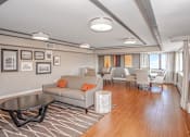 Thumbnail 21 of 43 - a living room with a couch and a table with chairs at 10 West Apartments, Long Beach, NY, 11561