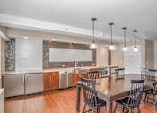 Thumbnail 19 of 43 - a kitchen and dining room with a table and chairs at 10 West Apartments, Long Beach