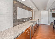 Thumbnail 20 of 43 - a long kitchen with granite counter tops and a sink at 10 West Apartments, New York
