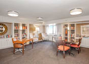 Thumbnail 16 of 43 - a club house with a table and chairs and a library at 10 West Apartments, Long Beach, New York
