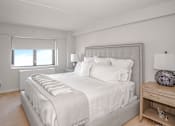 Thumbnail 13 of 43 - a bedroom with a large bed and a window at 10 West Apartments, Long Beach