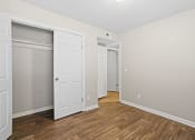Thumbnail 15 of 29 - a bedroom with a door to a closet and a hard wood floor at Diamond  Trail Apartments, Oklahoma, 73112
