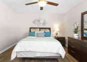 Thumbnail 13 of 29 - a bedroom with a bed and a ceiling fan at Diamond  Trail Apartments, Oklahoma, 73112