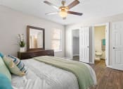 Thumbnail 14 of 29 - a bedroom with a large bed and a ceiling fan at Diamond  Trail Apartments, Oklahoma City