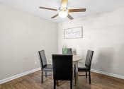 Thumbnail 6 of 29 - a dining room with a table and chairs and a ceiling fan at Diamond  Trail Apartments, Oklahoma City