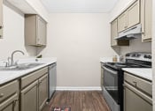 Thumbnail 1 of 29 - a kitchen with stainless steel appliances and white cabinets at Diamond  Trail Apartments, Oklahoma City, 73112