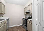 Thumbnail 2 of 29 - the kitchen of our studio apartment atrium with black appliances and white cabinets at Diamond  Trail Apartments, Oklahoma City, Oklahoma