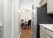 Thumbnail 4 of 29 - our apartments offer a kitchen and dining room with a black refrigerator at Diamond  Trail Apartments, Oklahoma City, OK, 73112
