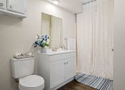 Thumbnail 11 of 24 - bathroom with white toilet and white cabinet with blue flowers on top