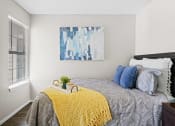 Thumbnail 8 of 24 - bedroom with yellow blanket on bed and blue pillows and blue painting
