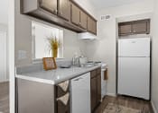 Thumbnail 2 of 24 - kitchen area with white refrigerator and brown cabinets