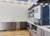 Thumbnail 27 of 48 - a kitchen with white countertops and gray cabinets