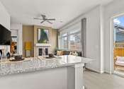Thumbnail 1 of 34 - a kitchen and living room with a fireplace at The Villas at Prairie Center, Brighton, Colorado
