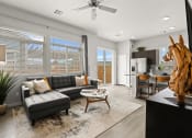 Thumbnail 5 of 34 - a living room with a couch and a coffee table in front of a window at The Villas at Prairie Center, Brighton, CO, 80601