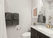 Thumbnail 15 of 34 - a bathroom with a toilet sink and mirror at The Villas at Prairie Center, Brighton, Colorado
