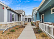 Thumbnail 20 of 34 - a row of houses with blue and purple siding at The Villas at Prairie Center, Brighton, Colorado