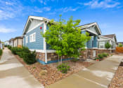 Thumbnail 21 of 34 - a blue house with a blue sky in the background at The Villas at Prairie Center, Brighton, CO