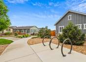 Thumbnail 33 of 34 - a park with a swing set in front of a house at The Villas at Prairie Center, Brighton, 80601