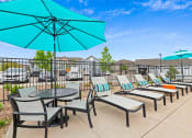 Thumbnail 30 of 34 - the reserve at bucklin hill patio with umbrellas and chairs at The Villas at Prairie Center, Brighton, Colorado