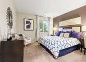 Thumbnail 18 of 44 - a bedroom with a large bed and a desk with a chair