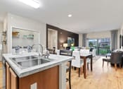 Thumbnail 1 of 44 - a kitchen and living room with a wooden floor and a large window