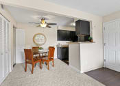 Thumbnail 4 of 40 - a dining room and kitchen with a ceiling fan at Silver Reef Apartments, Lakewood