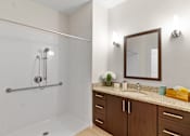 Thumbnail 10 of 30 - a bathroom with a shower and a sink at Cirrus Apartments, Massachusetts