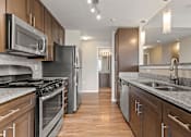Thumbnail 17 of 31 - a kitchen with stainless steel appliances and granite countertops