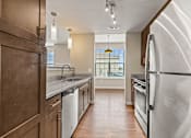 Thumbnail 16 of 31 - a kitchen with white appliances and a large window